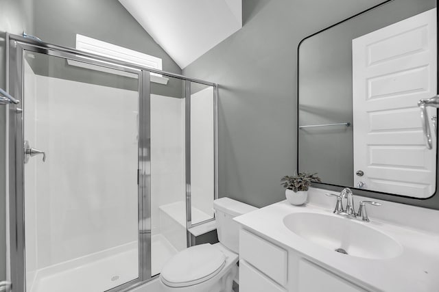 full bath with toilet, a shower stall, lofted ceiling, and vanity