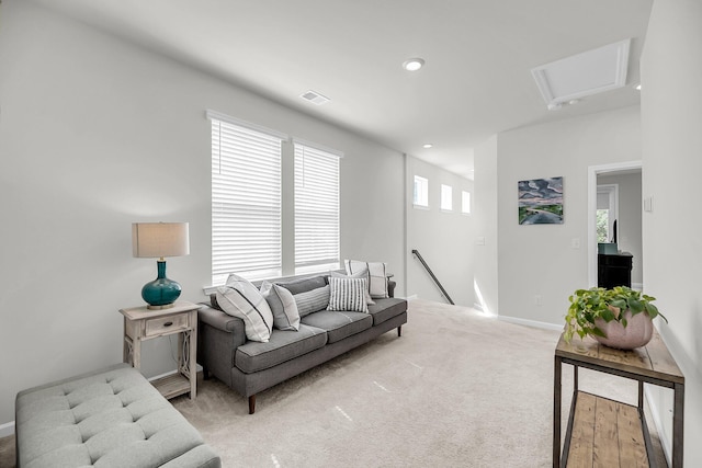 living room with light carpet, baseboards, and recessed lighting
