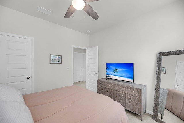 bedroom with light colored carpet and a ceiling fan