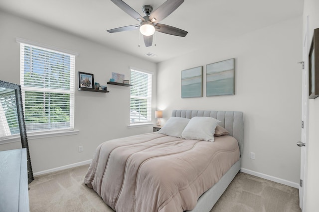 bedroom with baseboards, light colored carpet, and ceiling fan