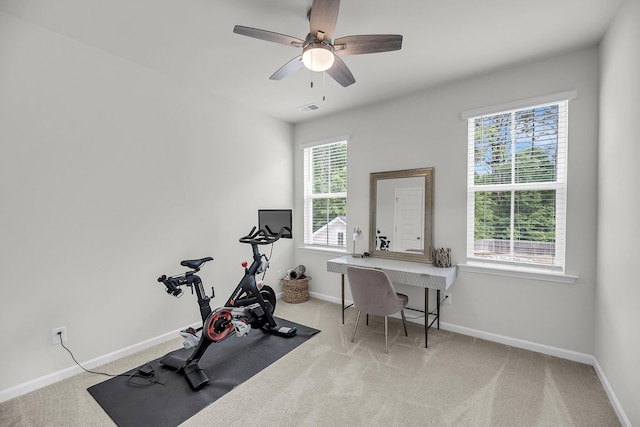 workout room with baseboards, carpet flooring, and ceiling fan
