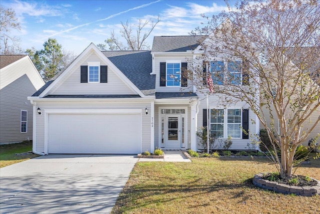 view of front of property featuring a front yard and a garage