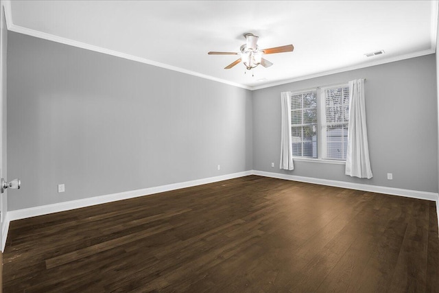 empty room with ceiling fan, dark hardwood / wood-style floors, and ornamental molding