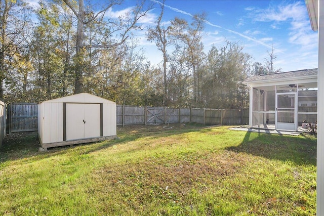 view of yard featuring a shed and a sunroom