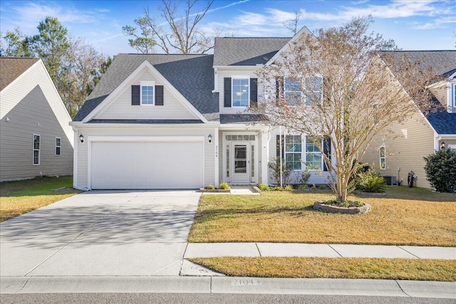 view of front of home featuring a front yard and a garage