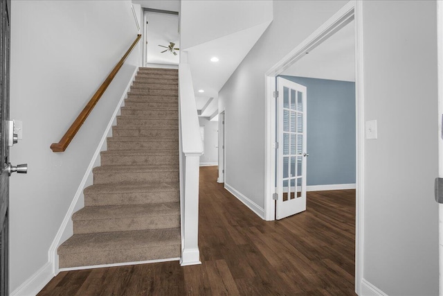 stairway featuring hardwood / wood-style floors and ceiling fan