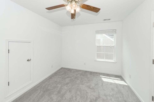 spare room featuring ceiling fan and light colored carpet