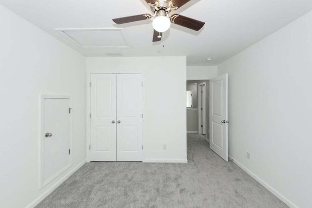 unfurnished bedroom with ceiling fan, a closet, and light colored carpet