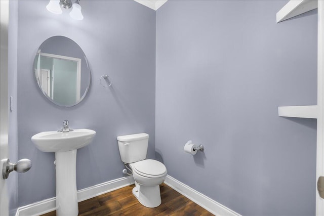 bathroom with wood-type flooring and toilet