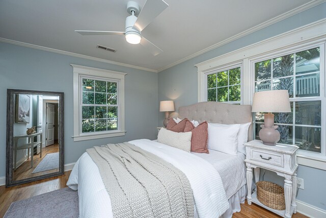 3002 Waterway Blvd, Isle Of Palms, SC 29451 - bedroom featuring multiple windows, wood finished floors, ornamental molding, and ceiling fan