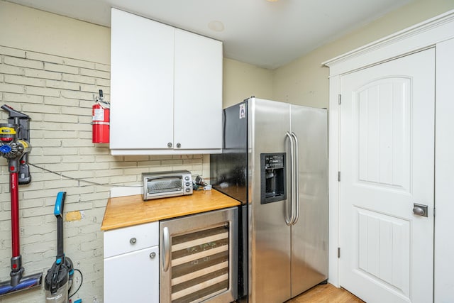 3002 Waterway Blvd, Isle Of Palms, SC 29451 - kitchen with stainless steel fridge with ice dispenser, beverage cooler, and white cabinetry