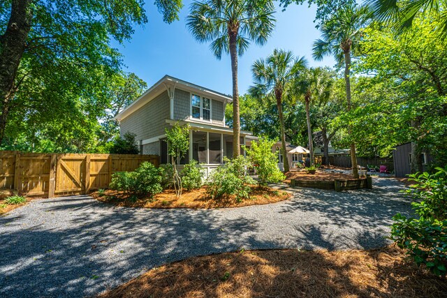 3002 Waterway Blvd, Isle Of Palms, SC 29451 - rear view of property featuring a sunroom and a gate