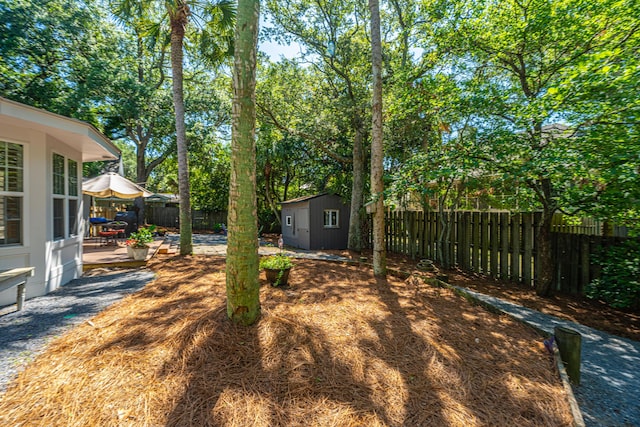3002 Waterway Blvd, Isle Of Palms, SC 29451 - fenced backyard with a shed, a patio area, and view of scattered trees