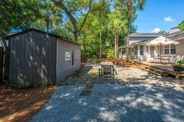 3002 Waterway Blvd, Isle Of Palms, SC 29451 - view of yard featuring an outbuilding, a wooden deck, and a patio area