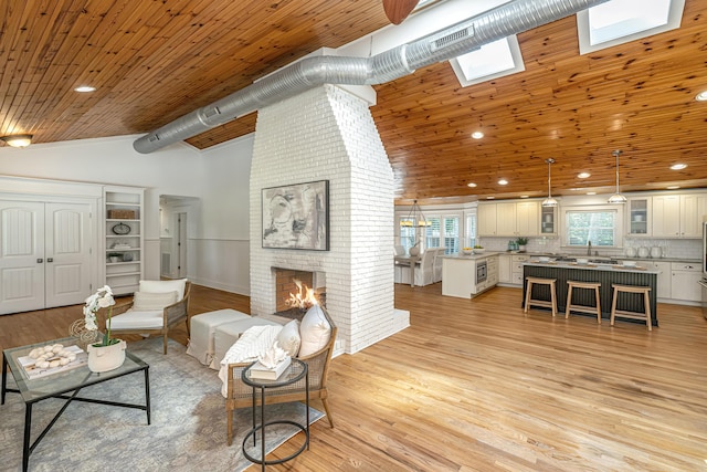3002 Waterway Blvd, Isle Of Palms, SC 29451 - living area with a fireplace, recessed lighting, light wood-style floors, high vaulted ceiling, and wood ceiling