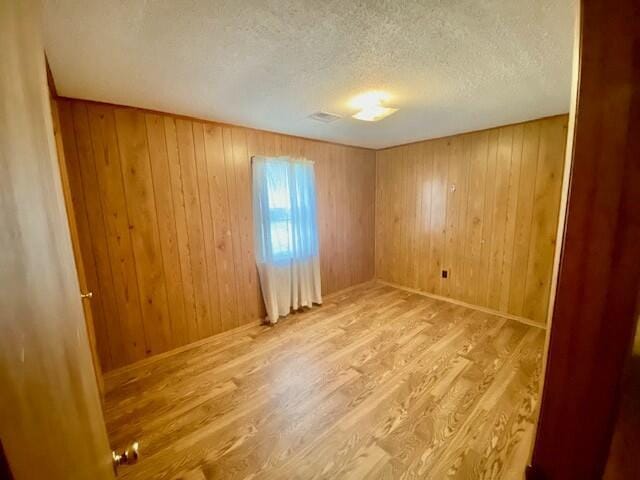 1806 S Charleston Ave, Fairfax, SC 29827 - unfurnished room with a textured ceiling, wood finished floors, and wooden walls