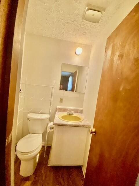 1806 S Charleston Ave, Fairfax, SC 29827 - half bath with wood finished floors, toilet, vanity, and a textured ceiling