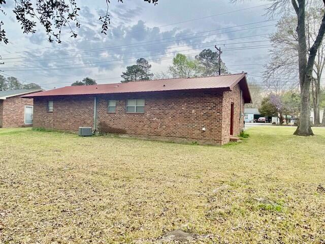 1806 S Charleston Ave, Fairfax, SC 29827 - rear view of house with cooling unit, brick siding, and a yard