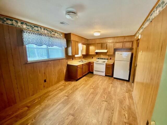 1806 S Charleston Ave, Fairfax, SC 29827 - kitchen featuring light countertops, light wood-style flooring, brown cabinets, range with electric stovetop, and freestanding refrigerator