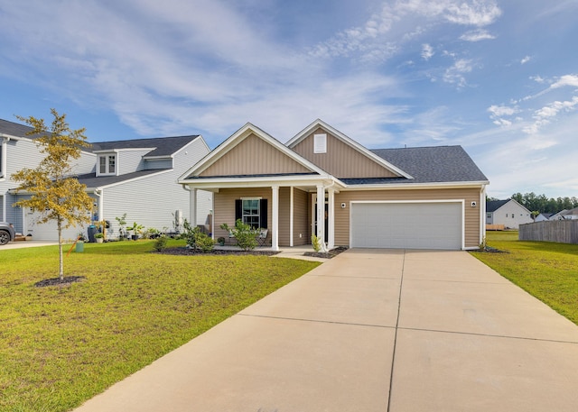 craftsman house featuring a garage, a front lawn, and covered porch