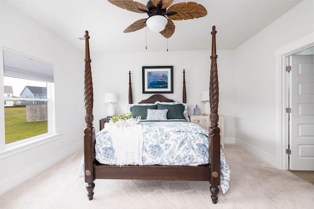 bedroom with ceiling fan and light colored carpet