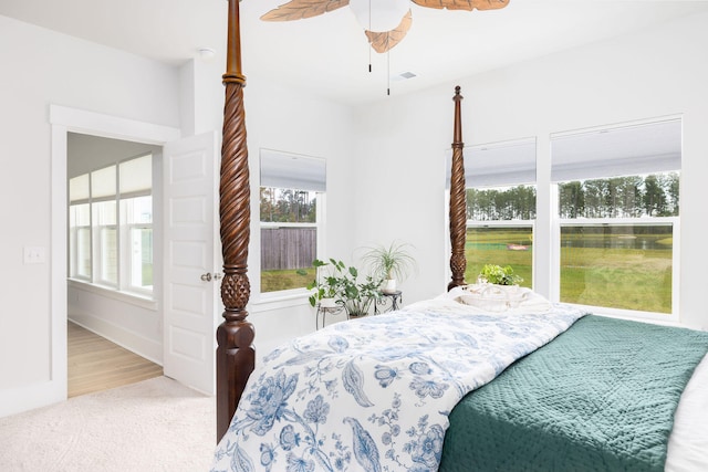 bedroom with light carpet and ceiling fan