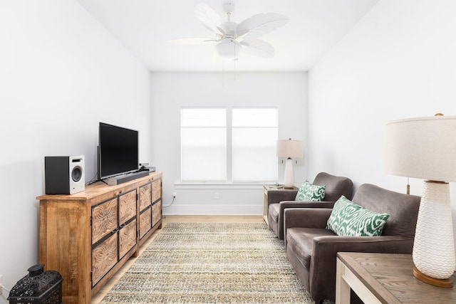 living room with light wood-type flooring and ceiling fan