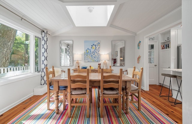 dining space featuring lofted ceiling, ornamental molding, wooden ceiling, and light hardwood / wood-style flooring