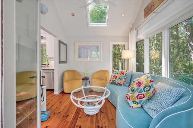 sunroom with vaulted ceiling with skylight and ceiling fan