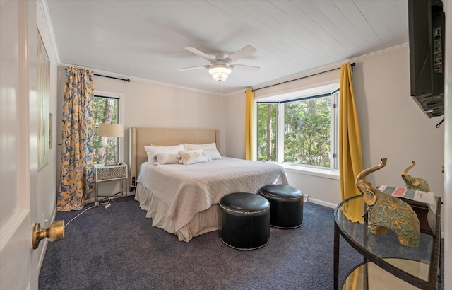 carpeted bedroom featuring ornamental molding, multiple windows, and ceiling fan