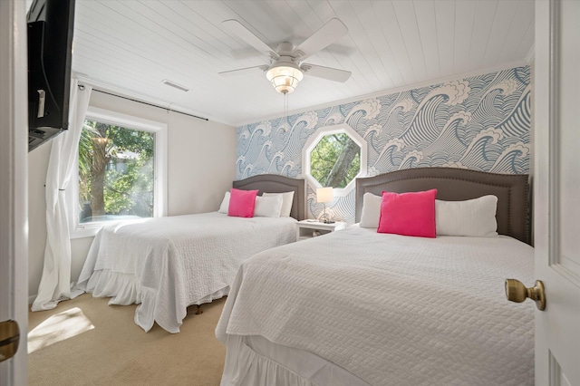 carpeted bedroom with ceiling fan, wood ceiling, and multiple windows