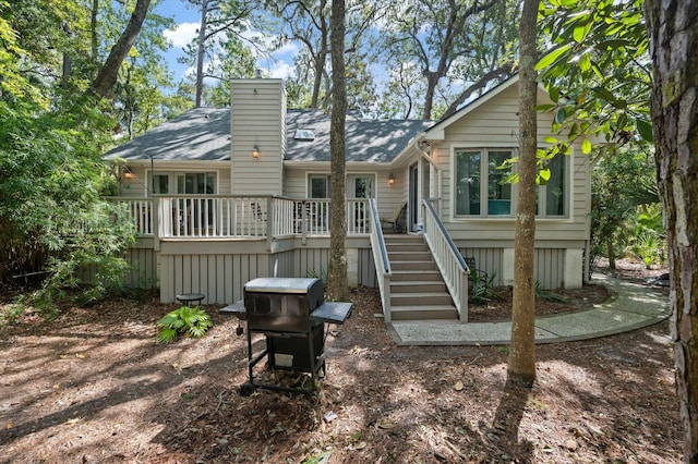 rear view of property featuring a deck