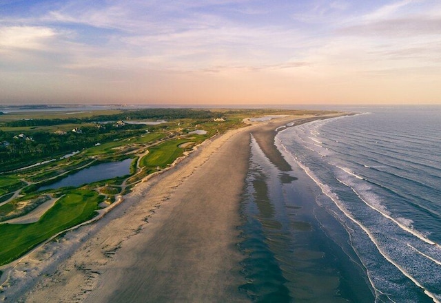 aerial view at dusk featuring a water view