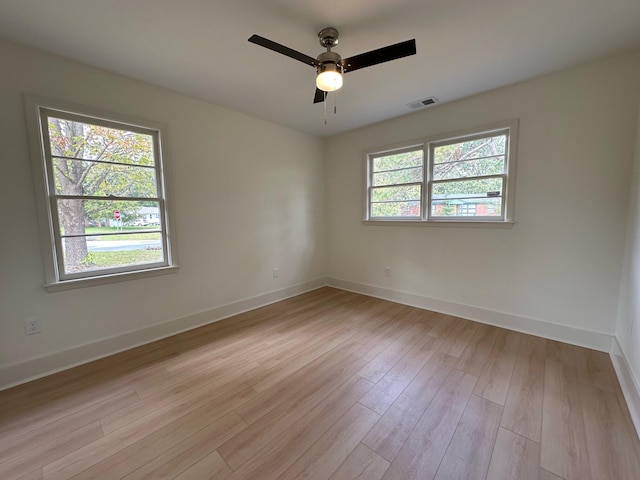 spare room with ceiling fan and light wood-type flooring