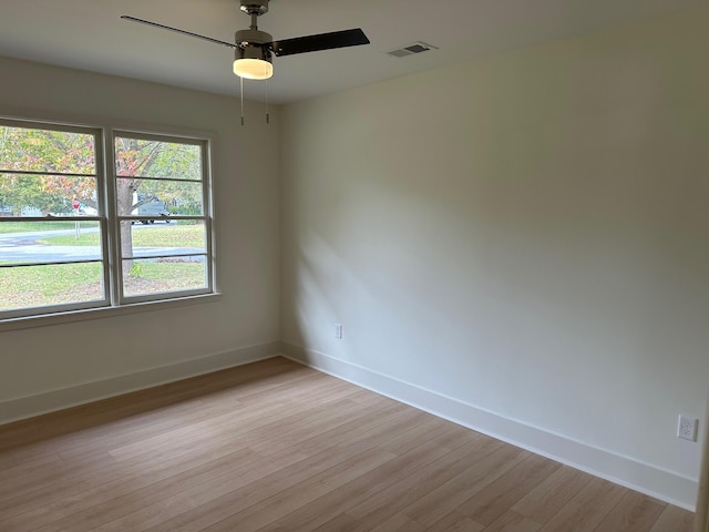 unfurnished room with light wood-type flooring and ceiling fan