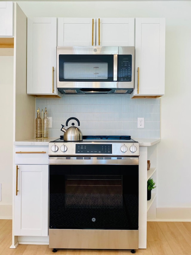 kitchen featuring white cabinetry, light hardwood / wood-style flooring, and appliances with stainless steel finishes