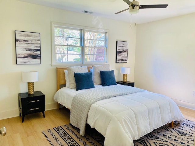 bedroom with light hardwood / wood-style flooring and ceiling fan