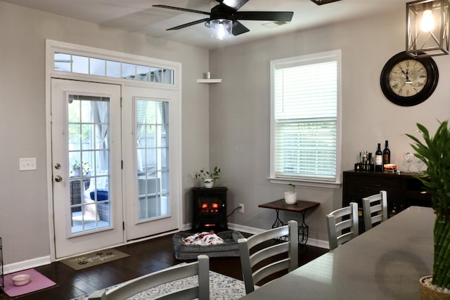 doorway to outside featuring a healthy amount of sunlight, dark wood-type flooring, and ceiling fan