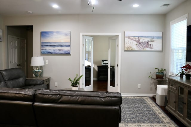 living room with french doors, ceiling fan, and dark hardwood / wood-style floors