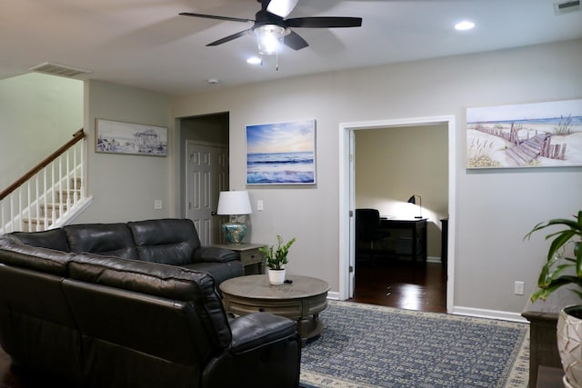 living room with dark wood-type flooring and ceiling fan