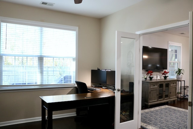 home office with ceiling fan, french doors, and dark hardwood / wood-style flooring