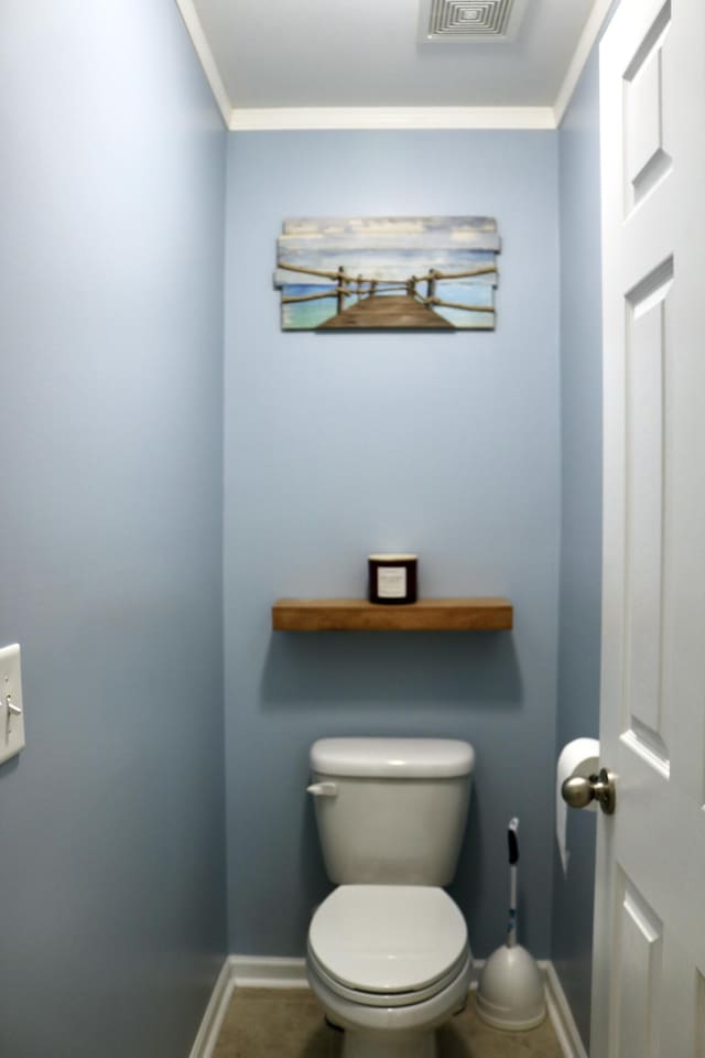 bathroom with toilet, tile patterned flooring, and crown molding