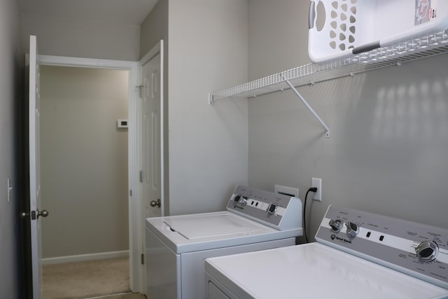 clothes washing area with washer and dryer and carpet flooring