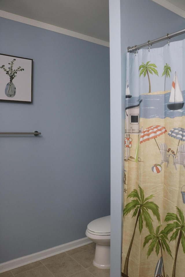 bathroom featuring toilet, tile patterned flooring, and crown molding