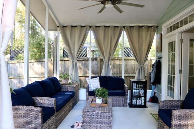 sunroom with ceiling fan and lofted ceiling