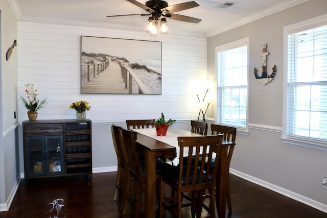 dining room with a wealth of natural light, crown molding, and dark wood-type flooring