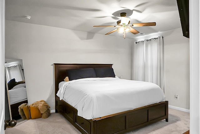 bedroom with light carpet, ceiling fan, and baseboards