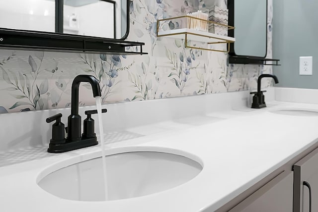 interior details featuring a sink and double vanity