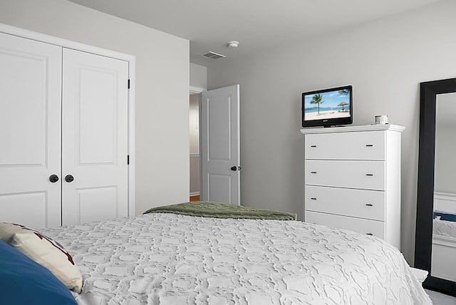 bedroom featuring visible vents and a closet