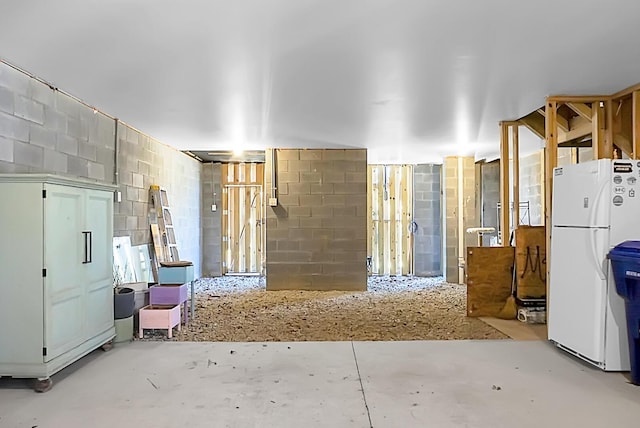 miscellaneous room featuring concrete block wall and concrete flooring